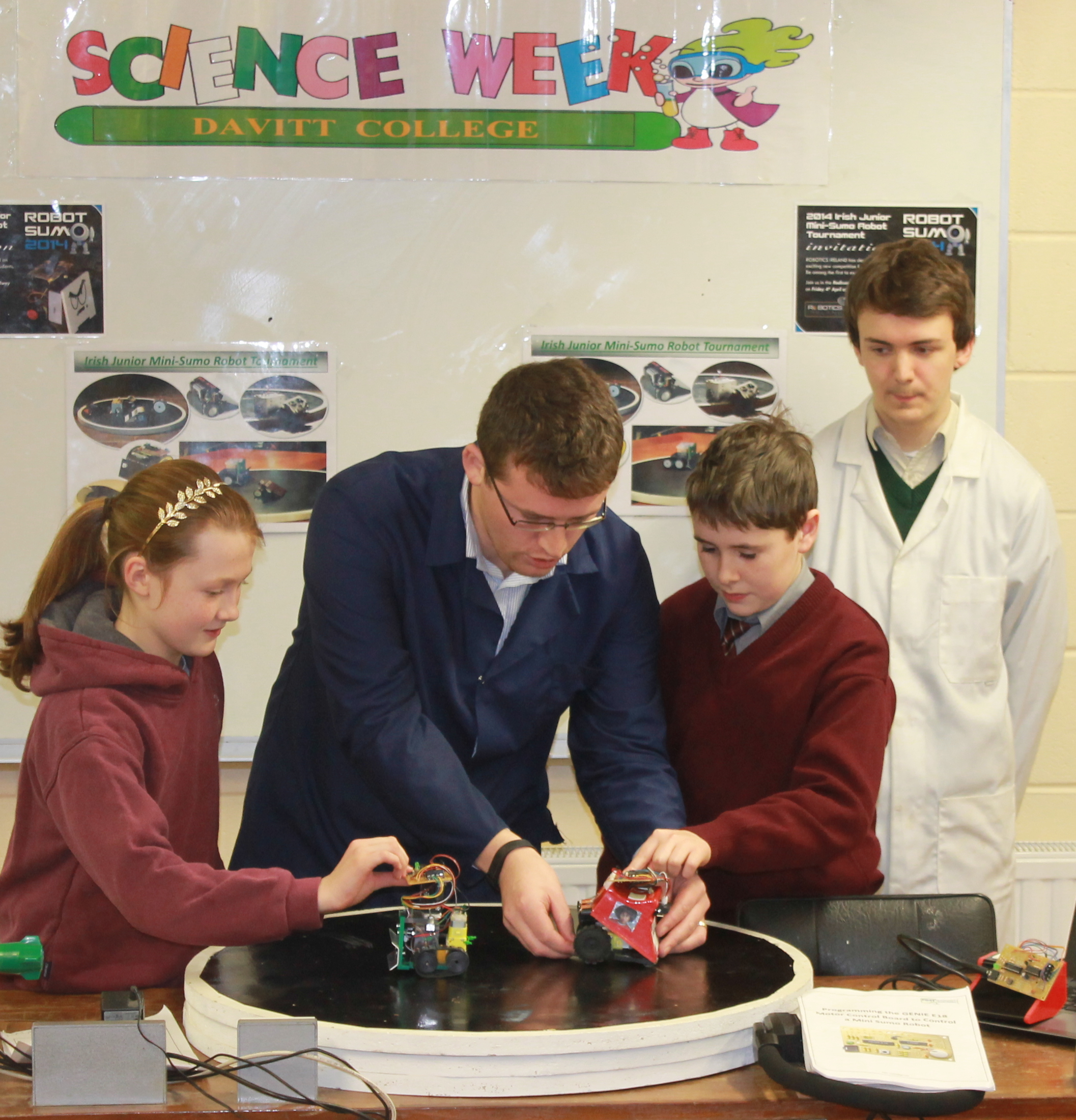 Davitt College Engineering Teacher, Mr. PJ McTavish and Transition Year Student Daniel Keighley demonstrate the team’s robots to Breaffy National School students during the annual Davitt College Science and Technology Event